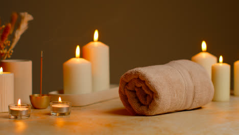 Still-Life-Of-Lit-Candles-With-Dried-Grasses-Incense-Stick-And-Soft-Towels-As-Part-Of-Relaxing-Spa-Day-Decor-5